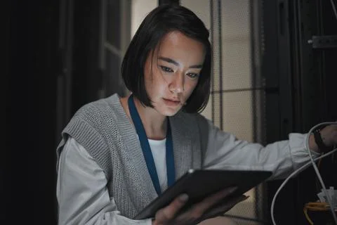 Tablet, server room and communication with a programmer asian woman at work on a Stock Photos