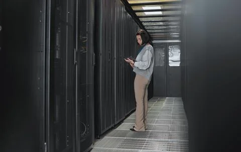 Tablet, server room and data center with a programmer asian woman at work on a Stock Photos