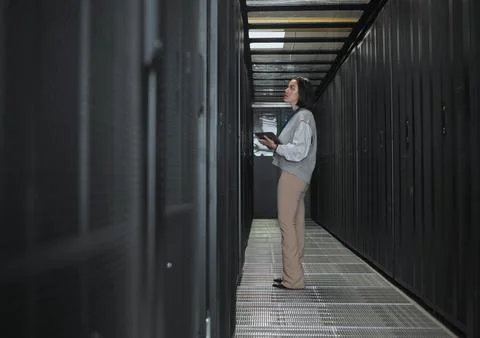 Tablet, server room and storage with a programmer asian woman at work on a 库存照片