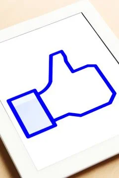 Tablet showing thumbs up Stock Photos