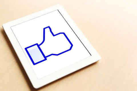 Tablet showing thumbs up Stock Photos