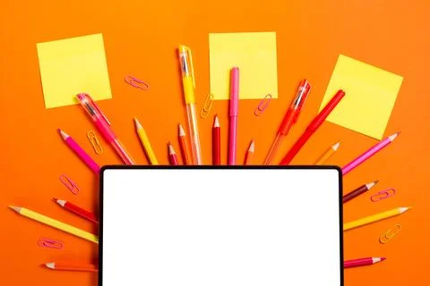 Tablet with Sticky Notes and School Supplies on Orange Background Stock Photos