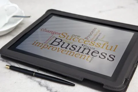 Tablet with successful business word cloud Stock Photos