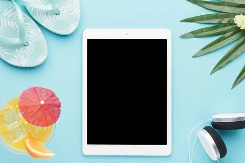 Tablet summer things colored background Stock Photos