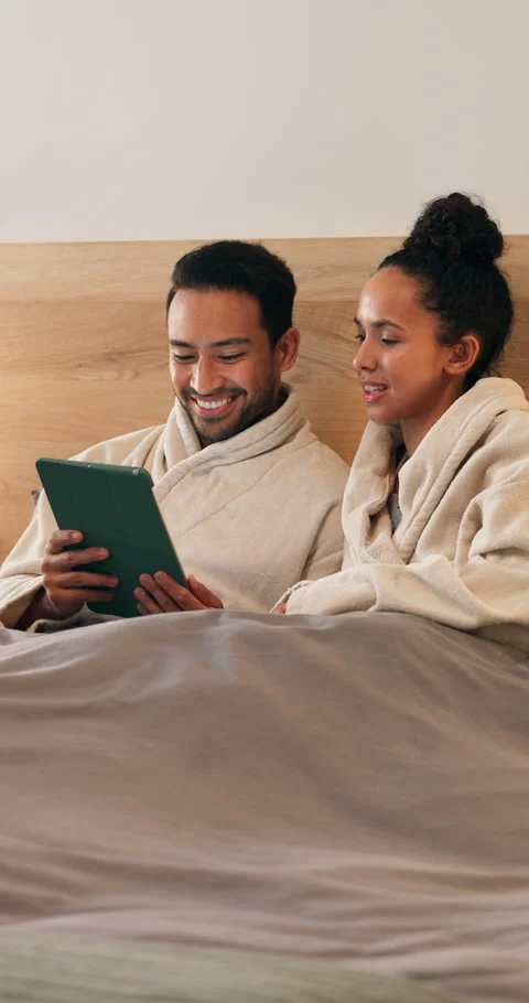 Tablet, talking and couple on bed in home with browsing social media, internet Stock Footage 340731598