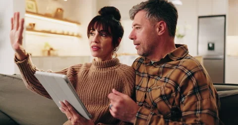 Tablet, talking and mature couple on home couch with internet connection, Stock Footage 338170718