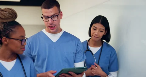 Tablet, talking and team with nurses in hospital for medical report, planning Stock Footage 335784954