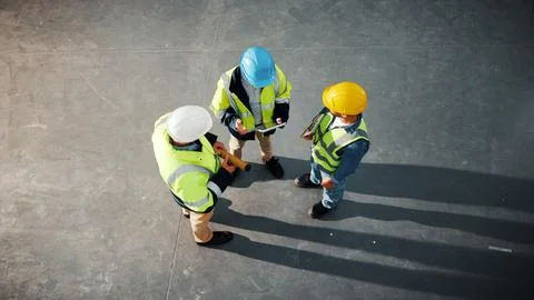 Tablet, team and engineer with above of people in building for inspection Stock Photos