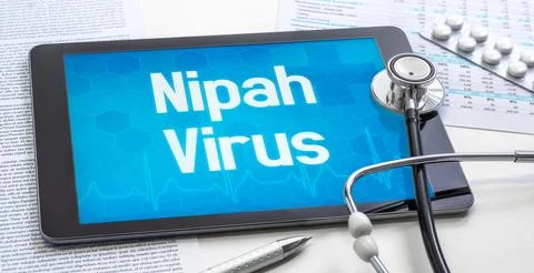 A tablet with text on the display - Nipah Virus Stock Photos