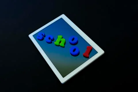 Tablet with text SCHOOL.Tablet PC, technology and education. Levitation, blac Stock Photos