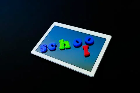 Tablet with text SCHOOL.Tablet PC, technology and education. Levitation, blac Stock Photos