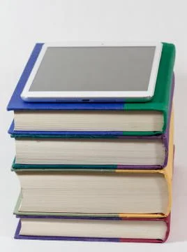 Tablet on top of books Stock Photos