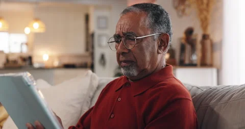 Tablet, typing and confused with old man on sofa for 404 error, communication Stock Footage 308062375