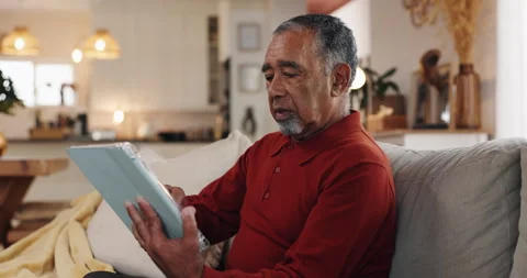 Tablet, typing and relax with old man on sofa for streaming, communication app Stock Footage 308061863