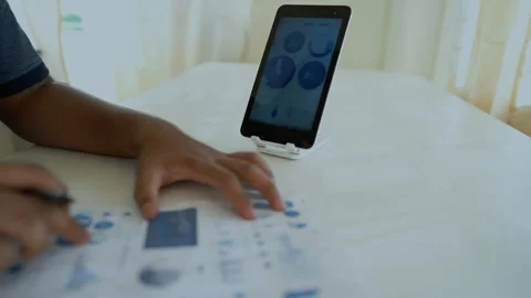 Tablet Use in Modern Office Setting, Person using a tablet on a stand with .. Stock Footage 317737006