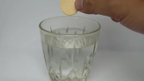 Tablet of Vitamin C Dissolving in Transparent Glass of Water Stock Footage 164153834