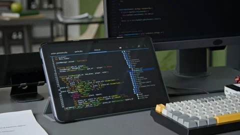 Tablet with Website Code and Computer on Desk of Developer at IT Company Video stock 335937938