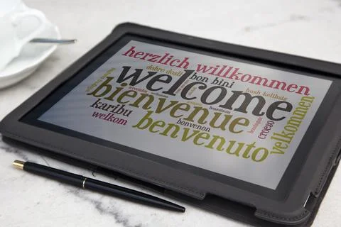 Tablet with welcome word cloud Stock Photos