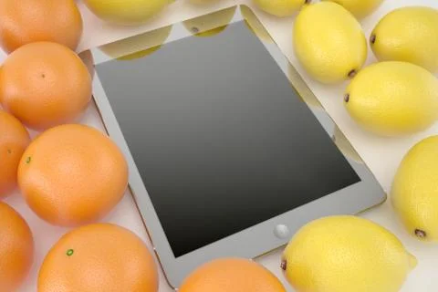 Tablet on white background with oranges and lemons Stock Photos
