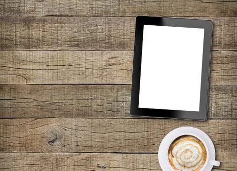 Tablet white screen display and coffee on old wood background Stock Photos