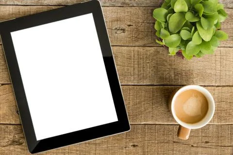 Tablet white screen display and coffee on wood table Stock Photos