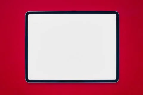 A tablet with a white screen on a red background Stock Photos