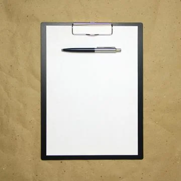 A tablet with a white sheet of A4 format on a beige craft paper. Stock Photos