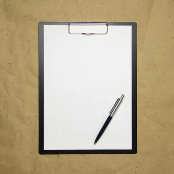 A tablet with a white sheet of A4 format on a beige craft paper. Stock Photos