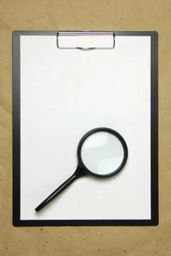 A tablet with a white sheet of A4 format on a beige craft paper. Foto stock