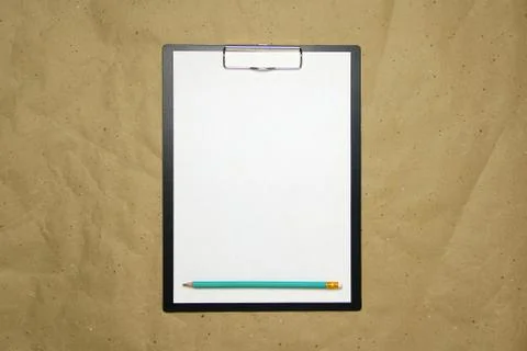 A tablet with a white sheet of A4 format on a beige craft paper. Stock Photos