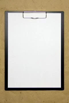 A tablet with a white sheet of A4 format on a beige craft paper. Stock Photos