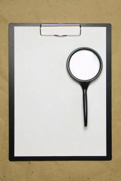 A tablet with a white sheet of A4 format on a beige craft paper. Stock Photos