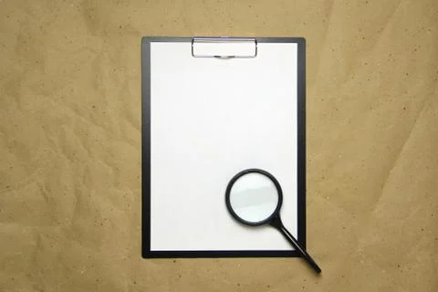 A tablet with a white sheet of A4 format on a beige craft paper. Foto stock