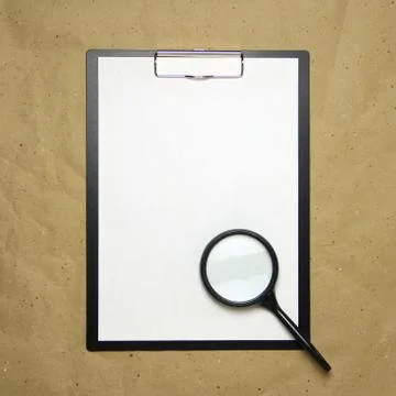 A tablet with a white sheet of A4 format on a beige craft paper. Stock Photos