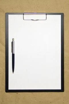 A tablet with a white sheet of A4 format on a beige craft paper. Stock Photos
