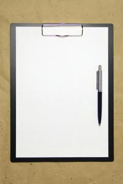 A tablet with a white sheet of A4 format on a beige craft paper. Stock Photos