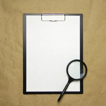 A tablet with a white sheet of A4 format on a beige craft paper. Stock Photos
