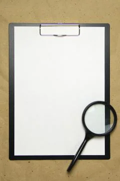 A tablet with a white sheet of A4 format on a beige craft paper. Stock Photos