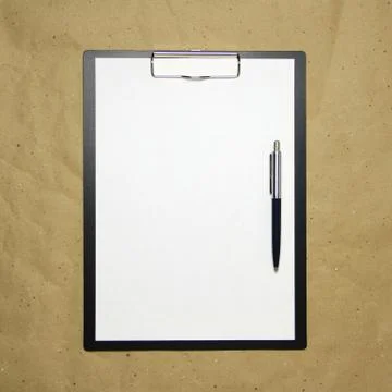 A tablet with a white sheet of A4 format on a beige craft paper. Stock Photos