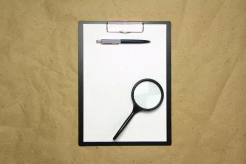 A tablet with a white sheet of A4 format on a beige craft paper. Stock Photos