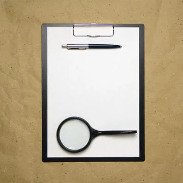 A tablet with a white sheet of A4 format on a beige craft paper. Stock Photos
