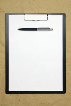 A tablet with a white sheet of A4 format on a beige craft paper. Stock Photos
