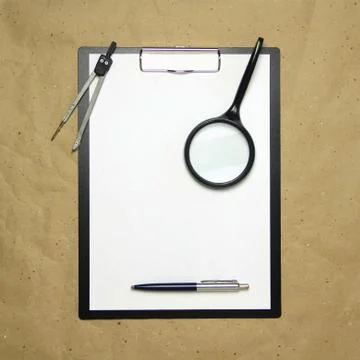 A tablet with a white sheet of A4 format on a beige craft paper. Stock Photos