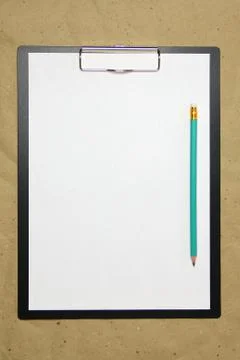A tablet with a white sheet of A4 format on a beige craft paper. Stock Photos