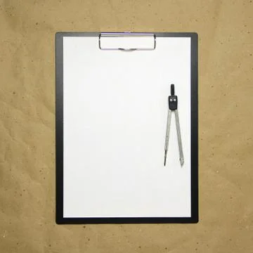 A tablet with a white sheet of A4 format on a beige craft paper. Stock Photos