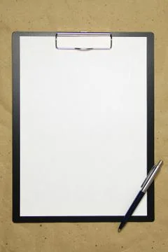 A tablet with a white sheet of A4 format on a beige craft paper. Stock Photos