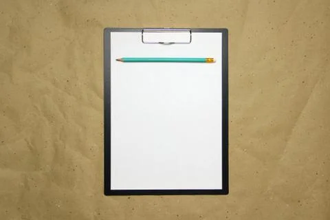 A tablet with a white sheet of A4 format on a beige craft paper. Foto stock