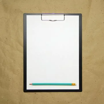 A tablet with a white sheet of A4 format on a beige craft paper. Stock Photos