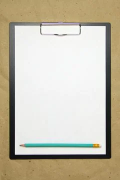 A tablet with a white sheet of A4 format on a beige craft paper. Stock Photos