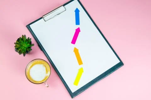 Tablet with a white sheet on which multicolored arrows show growth, success,  Stock Photos